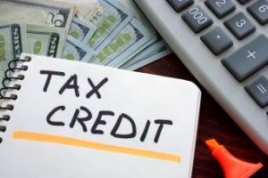"Tax Credit" written on a notepad.