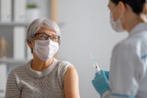 A woman getting vaccinated.