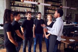 Six restaurant employees in a meeting.