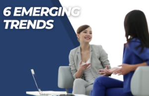 Two women talking in a meeting.