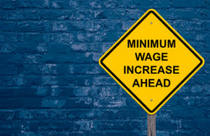Sign that reads "Minimum Wage Increase Ahead."