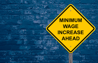 Sign saying "minimum wage increase ahead"