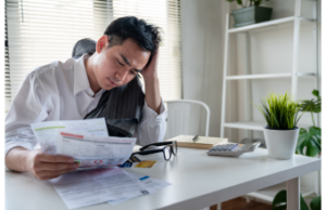 Frustrated man doing expenses