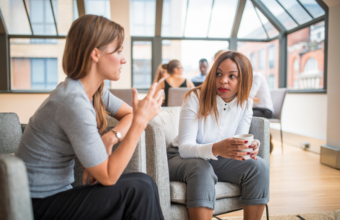 Seated women talking