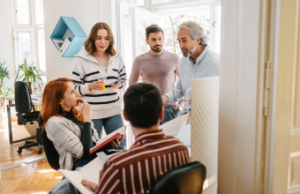 Manager delegating to team members during meeting