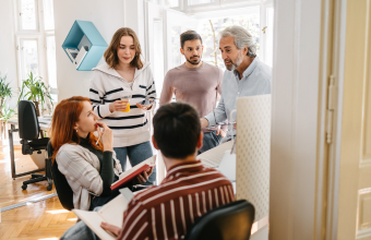 Manager delegating to team members during meeting