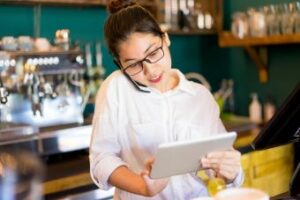 Female Restaurant Manager on Phone