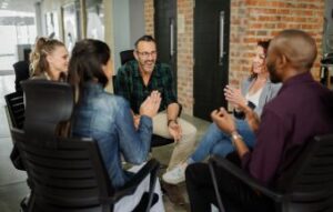 Upbeat team meeting seated in a circle