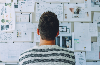 Man studying idea board for brainstorming