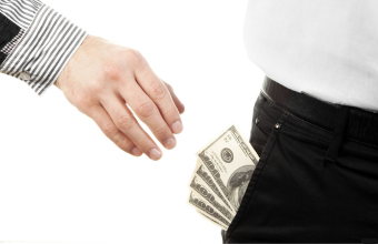 a hand pickpocketing cash from someone's pocket