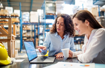 Employee training her replacement in warehouse setting