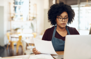 Restaurant manager dealing with payroll