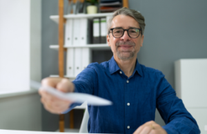 Handing over a paycheck to employee