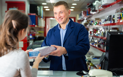 Worker giving a package to a client.