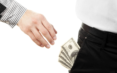 A hand pickpocketing cash from someone's pocket