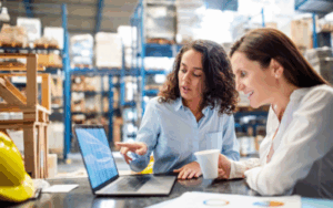 Employee training her replacement in warehouse setting