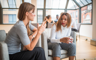 Two women sitting down having a conversation