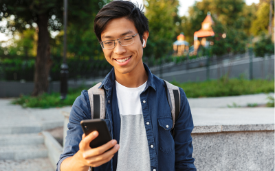 Young man smiling at smartphone