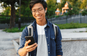 young man on smartphone looking at payday direct deposit