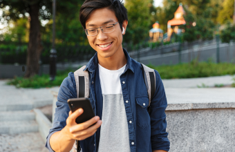young man on smartphone looking at payday direct deposit