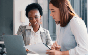Two employees working on a payroll audit.