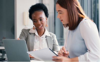 Two employees working on a payroll audit.