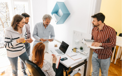 Manager delegating to team members during meeting