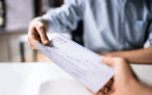 Person receiving an overtime check.