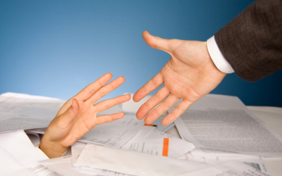 Helping hand with pile of paperwork for Year End AP reconciliation
