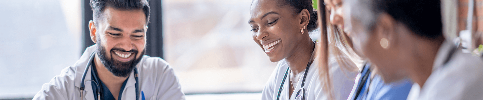 Multiple medical providers talking and laughing.