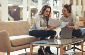 Two young business owners doing year end prep