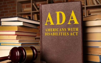 A variety of hard cover books in the background with the ADA Americans With Disabilities Act book on the front.