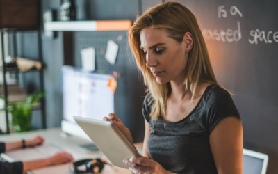Woman analyzing work on her tablet.