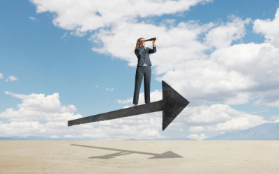 Woman standing on an arrow looking through a monocular.