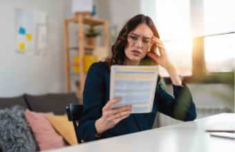 Woman reading paperwork perplexed