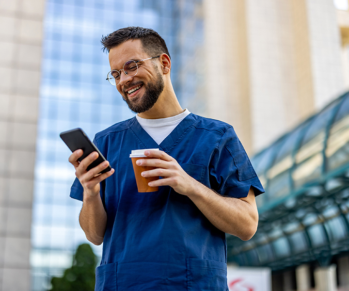 Male Nurse Using Smartphone On Coffee Break