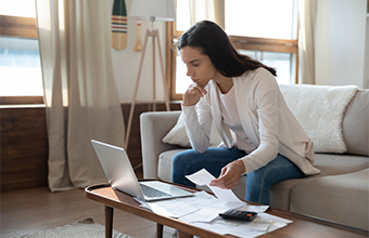 Woman working on open enrollment on her home computer
