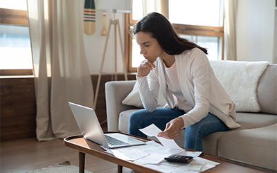 Woman in her living room doing paperwork