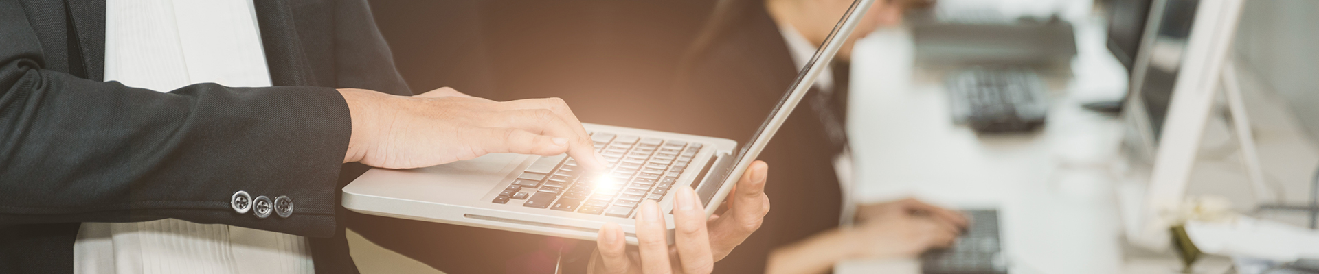 Person typing in their laptop