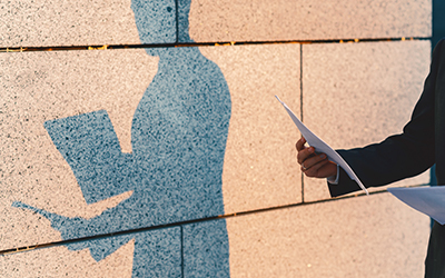 shadow of business man holding papers
