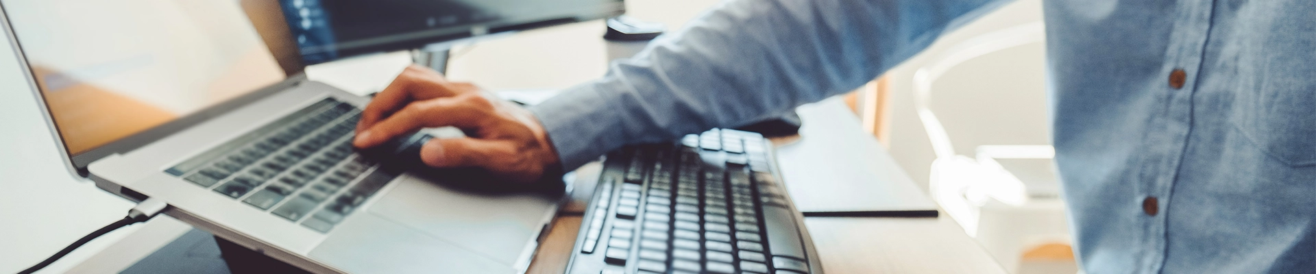 close up of hand at computer keyboard